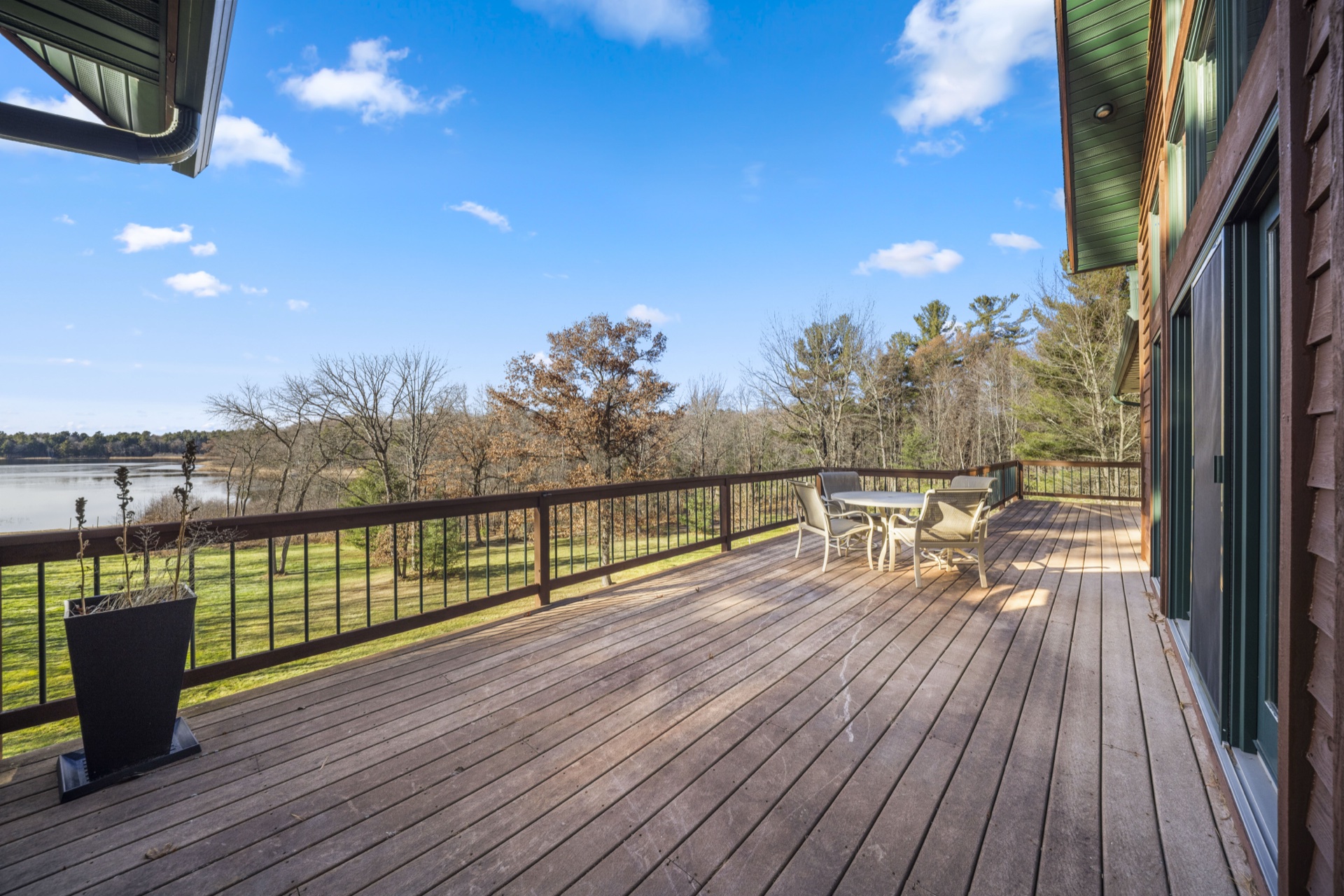 Upper level wrap-around deck with lake views and outdoor furniture