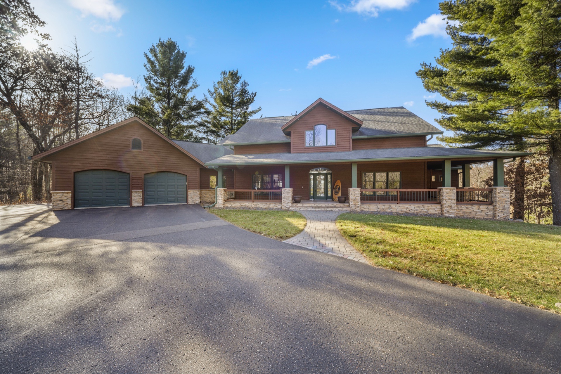 The Long Lake Lodge front exterior showing rustic architecture and mature landscaping