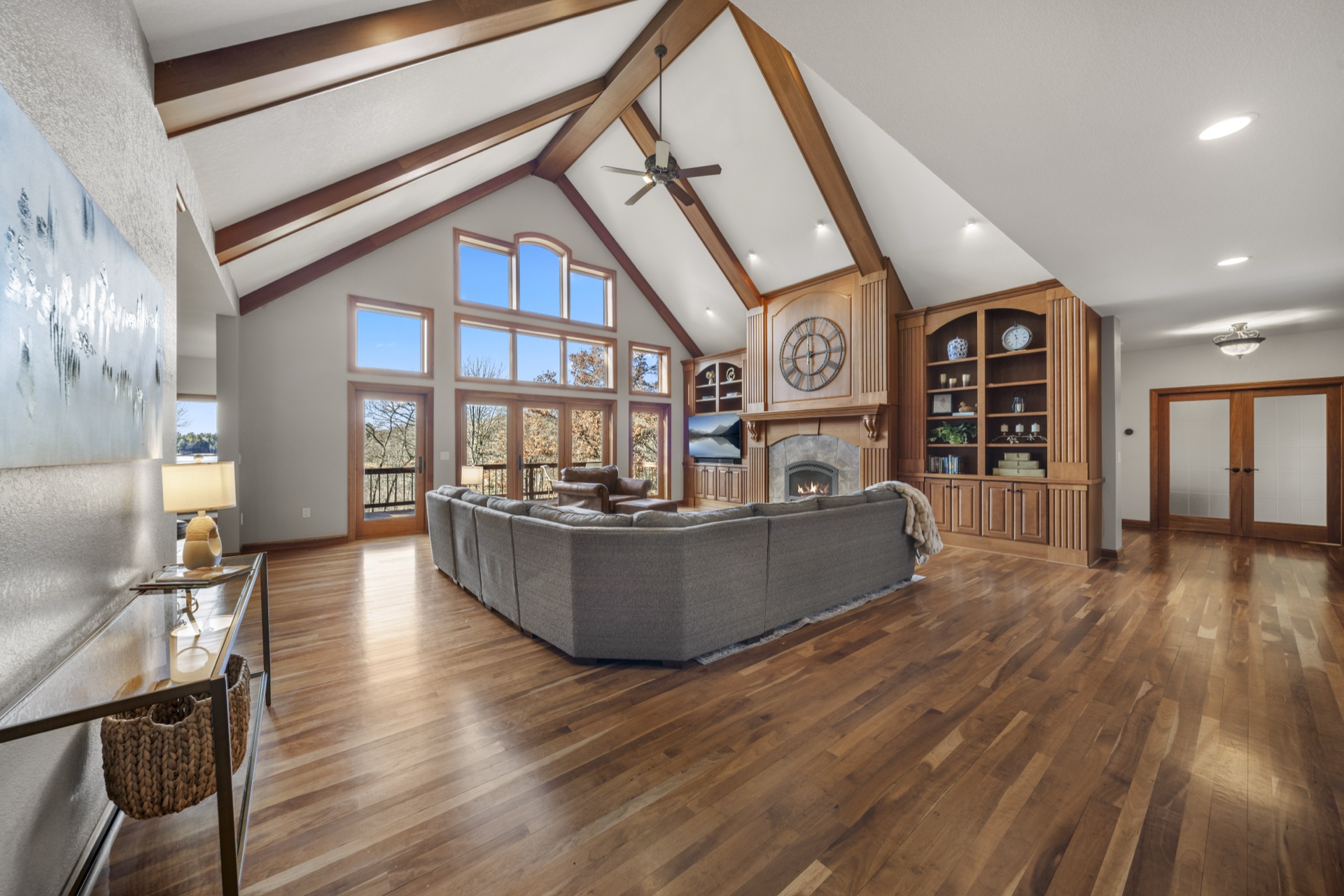 Living room with stone fireplace and custom built-in cabinetry