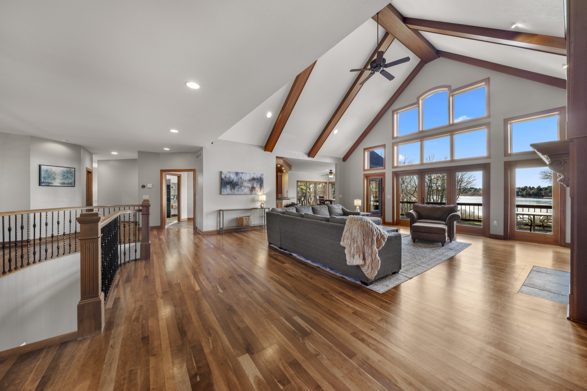 Overview of main living area with vaulted ceilings and lake views