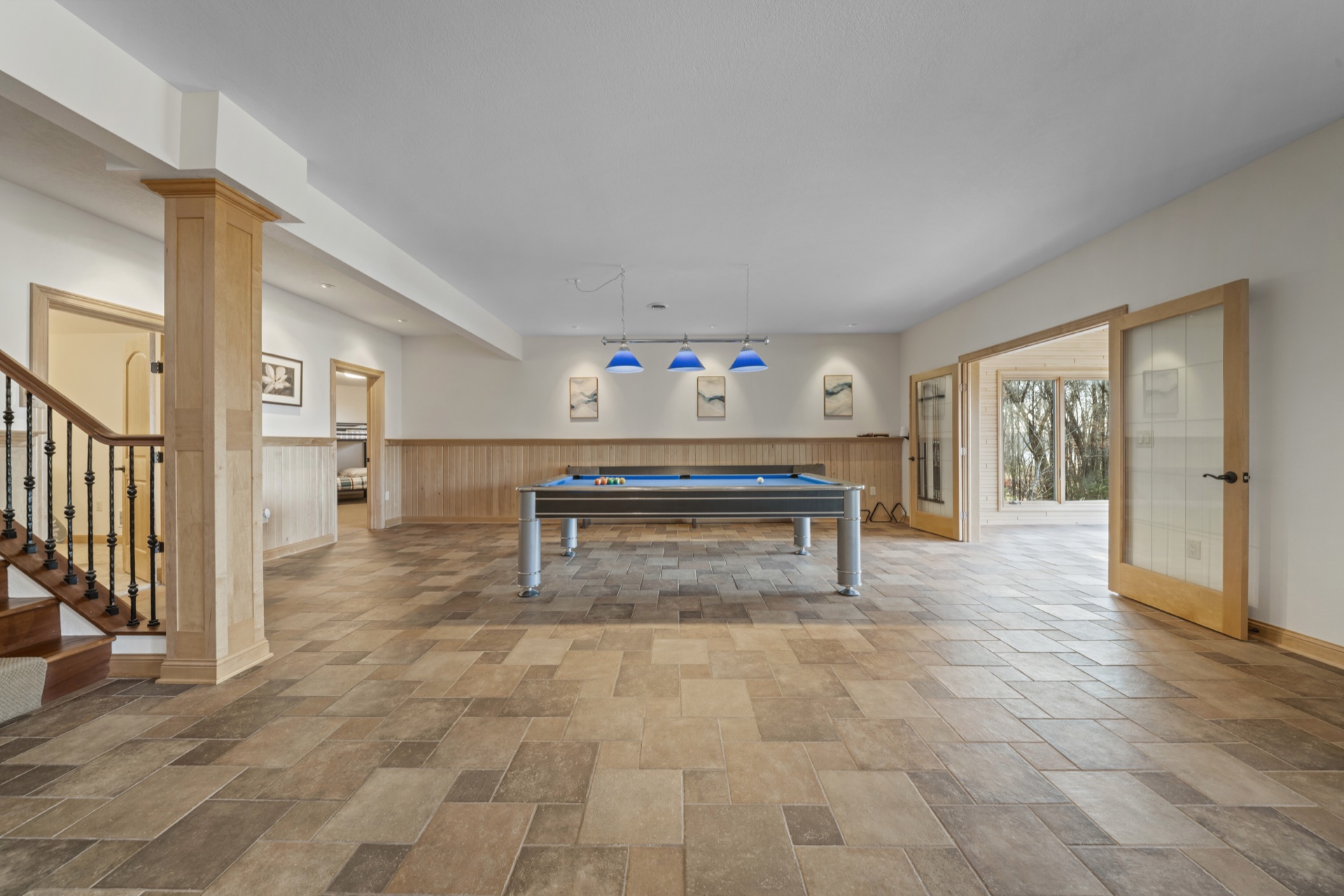 Pool table view in recreation room with seating areas